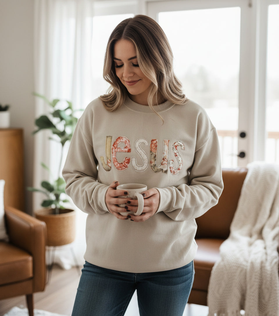 Sand sweatshirt with the word Jesus sewn on to the shirt
